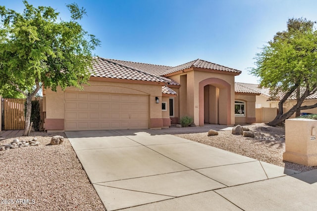 2226 N Gentry, Mesa, AZ 85213 - mediterranean / spanish home with a garage, stucco siding, concrete driveway, and a tiled roof