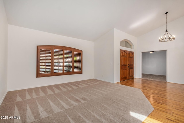 2226 N Gentry, Mesa, AZ 85213 - spare room featuring a chandelier, high vaulted ceiling, baseboards, and wood finished floors