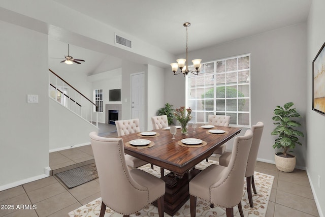 1811 S 39th St Unit 30, Mesa, AZ 85206 - dining room with light tile patterned floors, a chandelier, baseboards, stairs, and lofted ceiling
