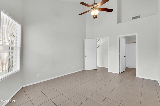 1811 S 39th St Unit 30, Mesa, AZ 85206 - unfurnished bedroom featuring a towering ceiling, light tile patterned floors, a spacious closet, baseboards, and a ceiling fan