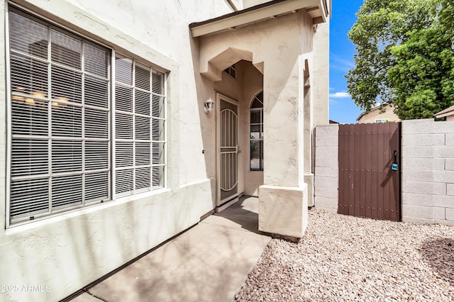 1811 S 39th St Unit 30, Mesa, AZ 85206 - property entrance with a gate, fence, and stucco siding