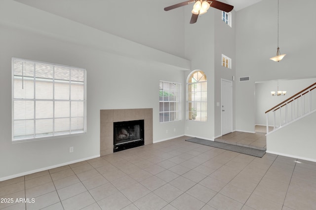 1811 S 39th St Unit 30, Mesa, AZ 85206 - unfurnished living room featuring tile patterned floors, a ceiling fan, stairway, a fireplace, and baseboards