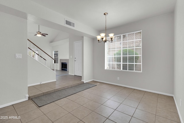1811 S 39th St Unit 30, Mesa, AZ 85206 - spare room featuring light tile patterned floors, a chandelier, baseboards, stairway, and lofted ceiling