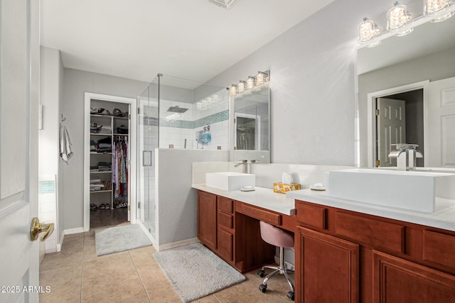 bathroom featuring tile patterned floors, vanity, and a shower with door