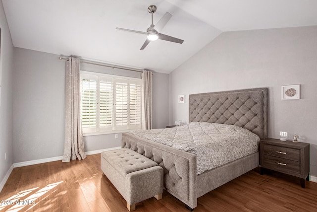 bedroom with ceiling fan, wood-type flooring, and vaulted ceiling