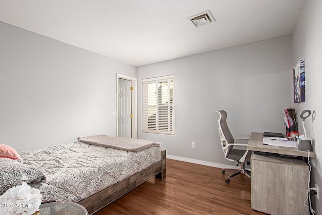 bedroom with wood-type flooring