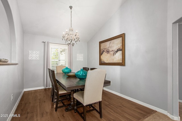 dining space featuring a chandelier, dark hardwood / wood-style flooring, and lofted ceiling