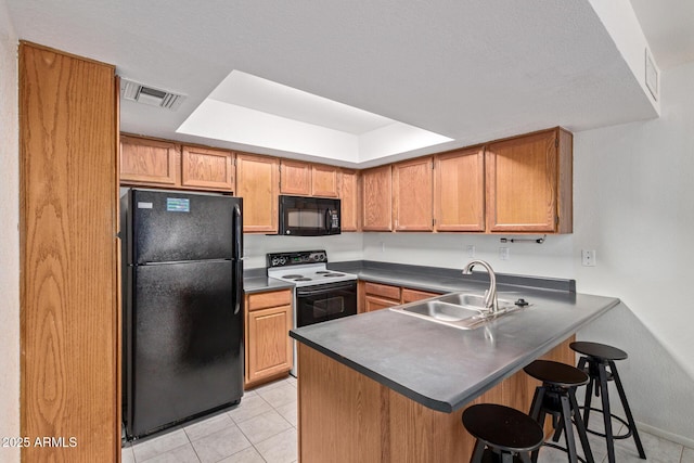 609 E Mesquite Cir Unit D133, Tempe, AZ 85288 - kitchen featuring black appliances, a peninsula, dark countertops, light tile patterned floors, and a kitchen bar