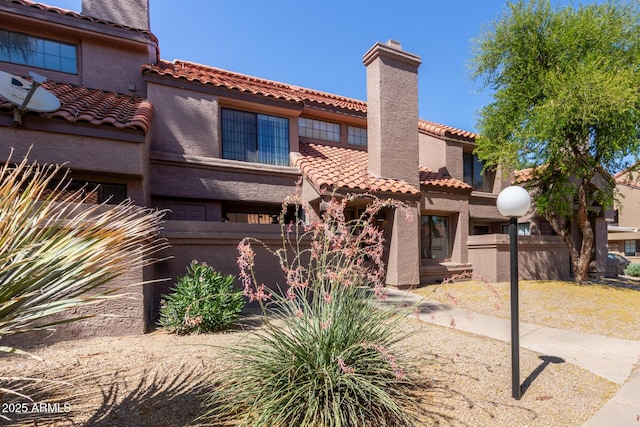 609 E Mesquite Cir Unit D133, Tempe, AZ 85288 - view of front of home featuring a chimney, a tile roof, and stucco siding