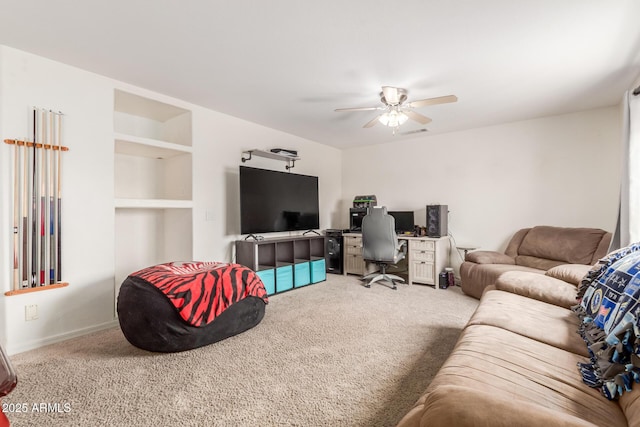 carpeted living room featuring visible vents, built in shelves, and ceiling fan