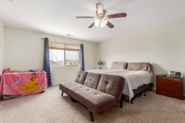 carpeted bedroom featuring visible vents and a ceiling fan