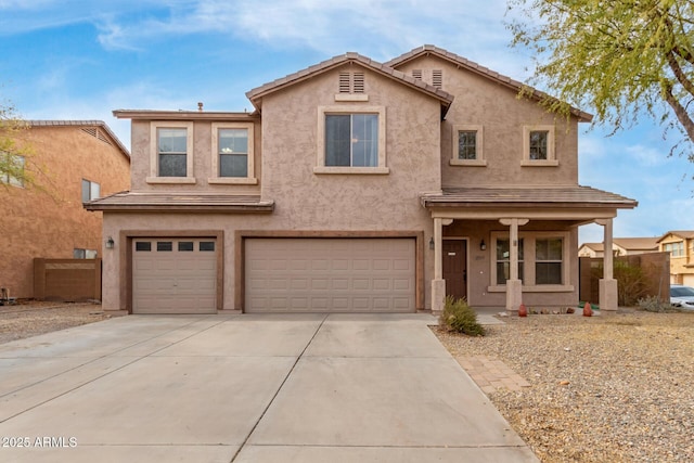 traditional-style house featuring stucco siding, concrete driveway, and a garage