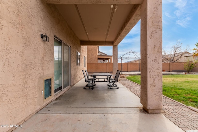 view of patio with outdoor dining space and a fenced backyard