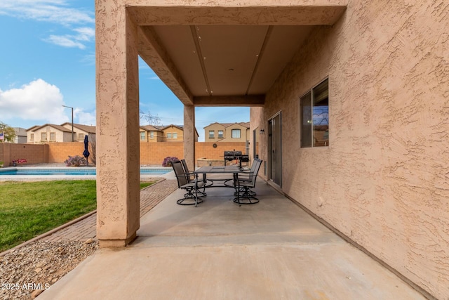 view of patio featuring a fenced in pool, a fenced backyard, and outdoor dining space