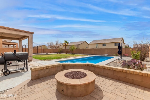 view of pool featuring a patio, a fire pit, a fenced in pool, and a fenced backyard