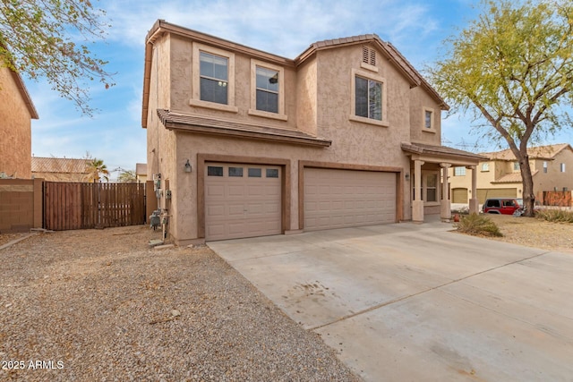 traditional-style house with a gate, fence, an attached garage, stucco siding, and concrete driveway