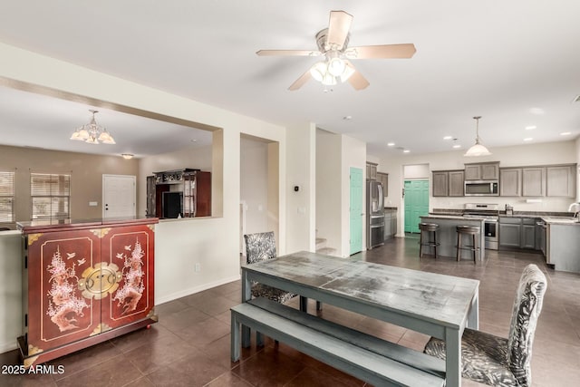 dining space with recessed lighting, baseboards, dark tile patterned floors, and a ceiling fan