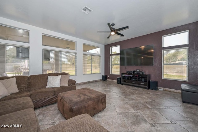 living room featuring plenty of natural light and ceiling fan