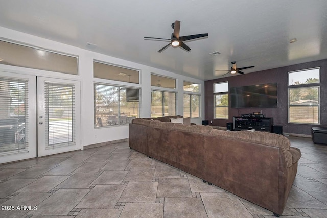 living room featuring french doors and ceiling fan