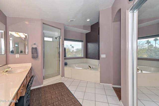 bathroom with tile patterned floors, a wealth of natural light, and plus walk in shower