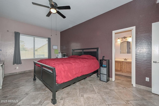 bedroom featuring ceiling fan and ensuite bath