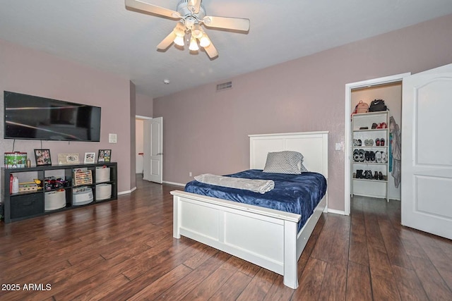 bedroom with ceiling fan and dark wood-type flooring