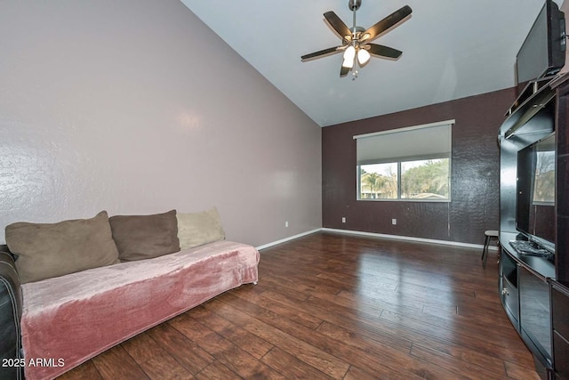 living room with ceiling fan, dark wood-type flooring, and vaulted ceiling