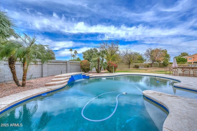 view of swimming pool with pool water feature