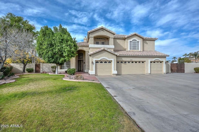 mediterranean / spanish home with a front yard and a garage