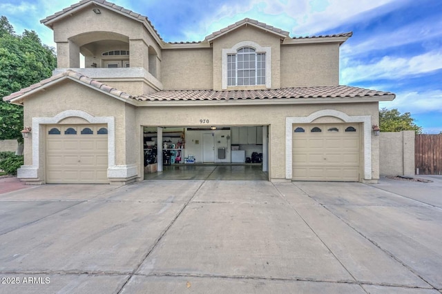 mediterranean / spanish-style house with a garage