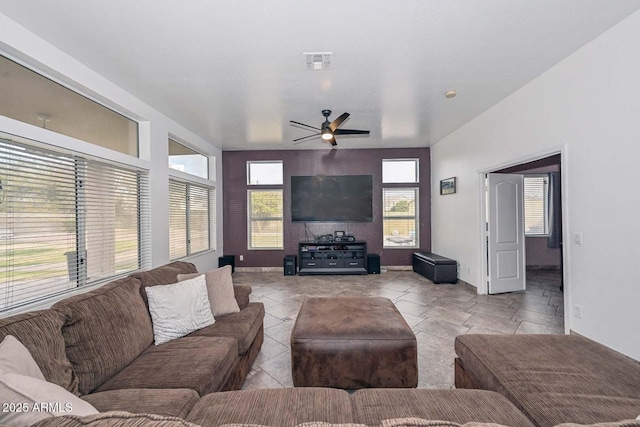 living room featuring ceiling fan and a wealth of natural light