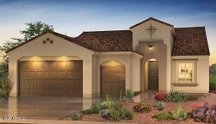 mediterranean / spanish house with a garage, driveway, and stucco siding