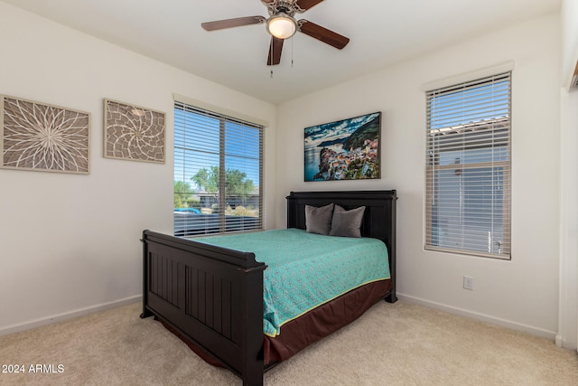 bedroom with light carpet and ceiling fan