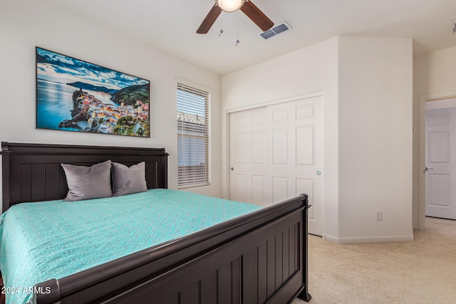 carpeted bedroom with a closet and ceiling fan