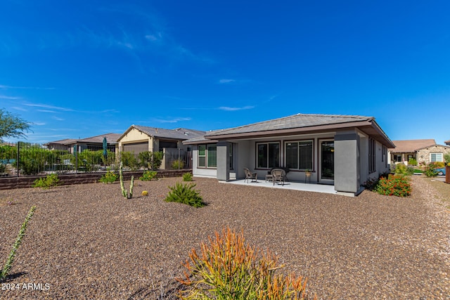 back of property with a patio