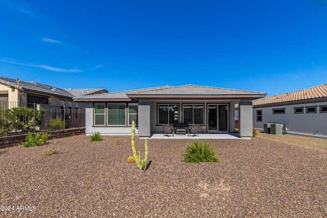 rear view of property featuring a patio area and central AC