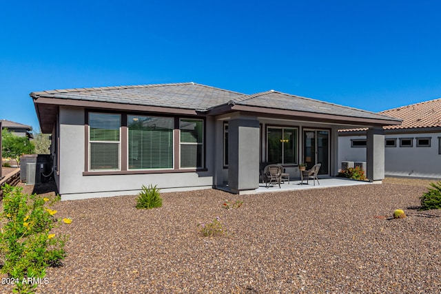 back of property with a patio and central air condition unit