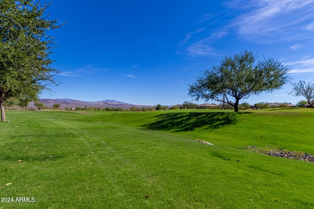 view of property's community featuring a mountain view and a lawn