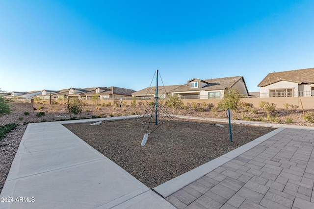 view of jungle gym with a residential view and fence