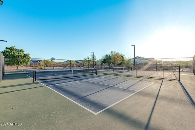 view of sport court featuring fence