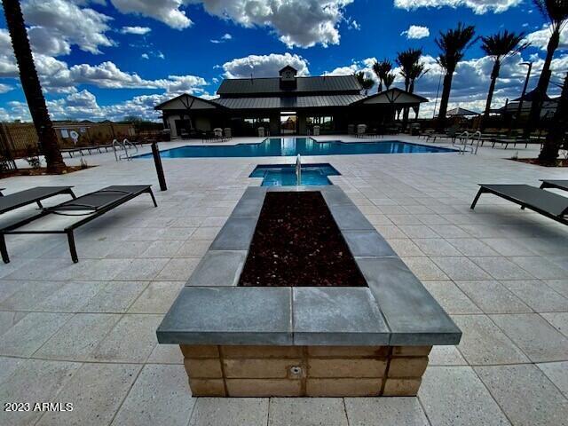 pool featuring a patio and a hot tub