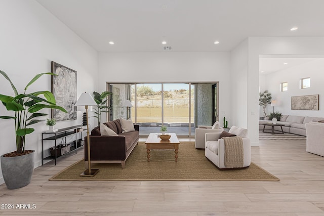 living room featuring recessed lighting, visible vents, and light wood-style flooring