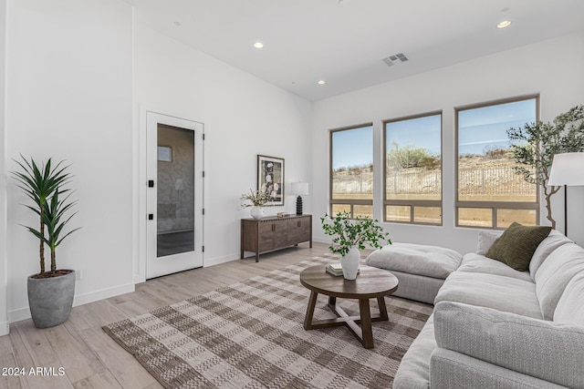 living area featuring light wood-style flooring, recessed lighting, visible vents, and baseboards