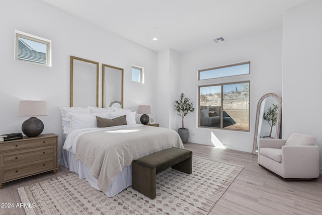 bedroom featuring visible vents, recessed lighting, light wood-type flooring, and baseboards