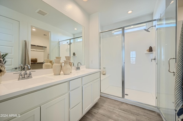 bathroom with vanity, hardwood / wood-style flooring, and walk in shower