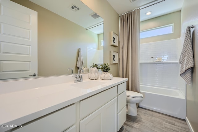 full bathroom featuring shower / tub combo with curtain, vanity, toilet, and hardwood / wood-style floors