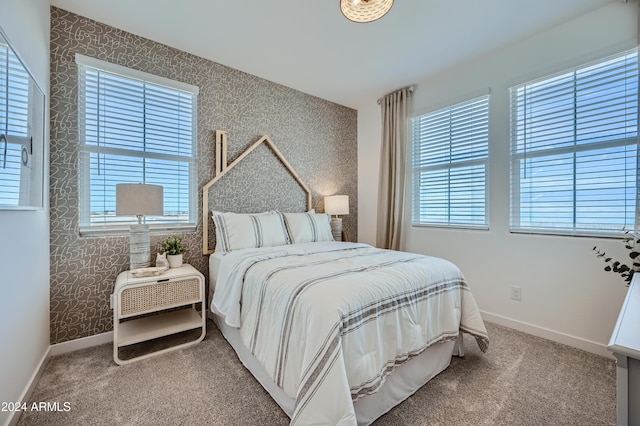 bedroom featuring carpet floors and multiple windows