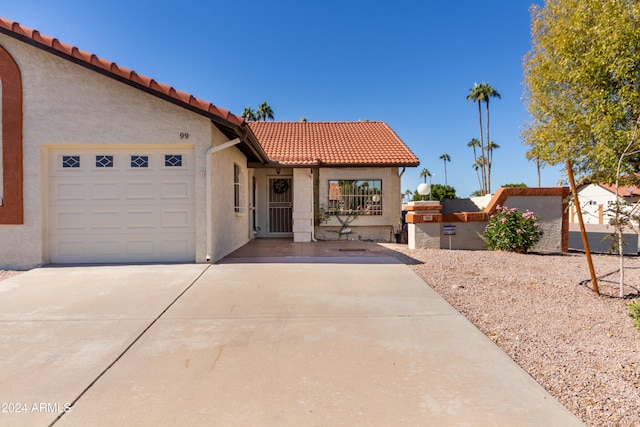 mediterranean / spanish house with a garage