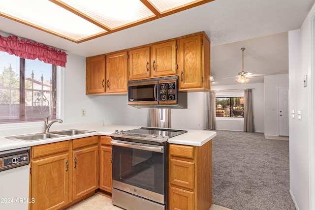 kitchen featuring dishwasher, stainless steel range with electric cooktop, sink, ceiling fan, and kitchen peninsula