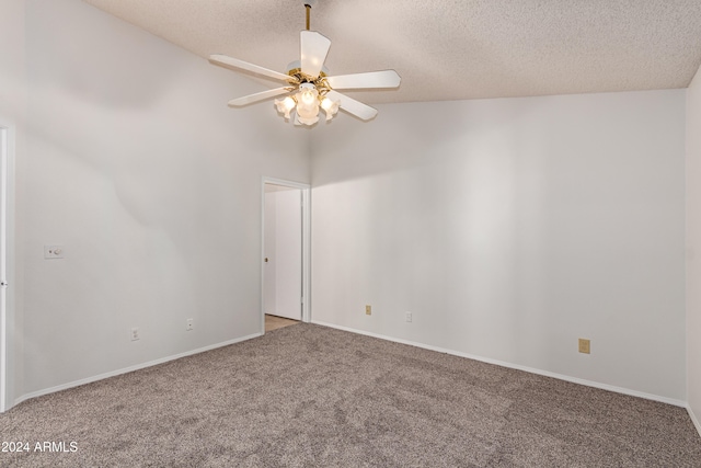 unfurnished room with a textured ceiling, ceiling fan, carpet floors, and lofted ceiling